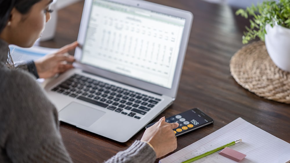A person calculating their budget.
