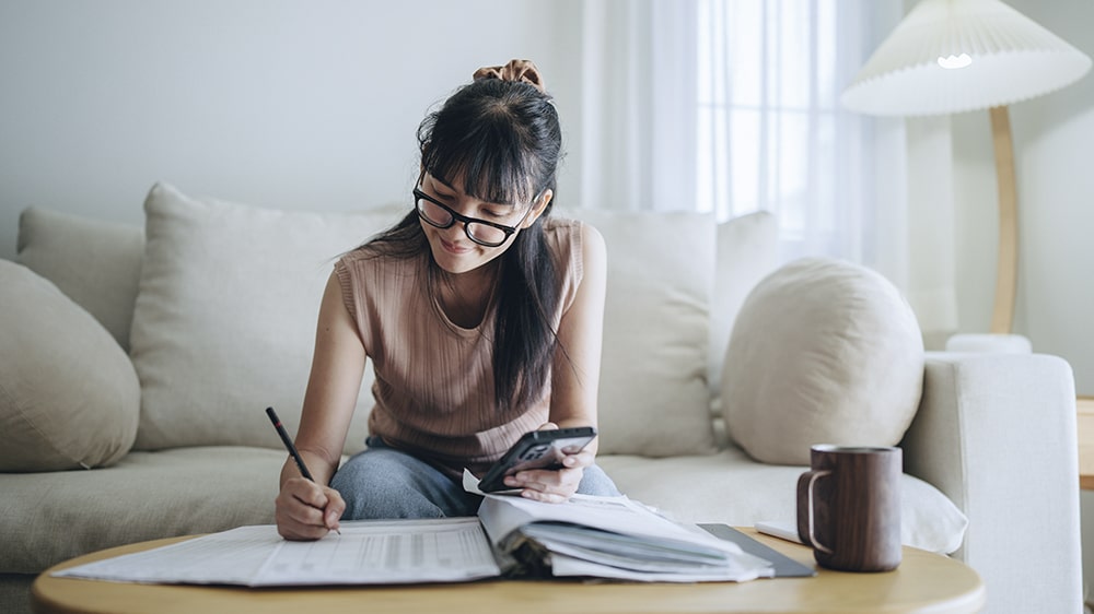 A woman organizing her monthly budget.