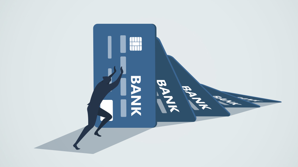 Man pushing away credit cards